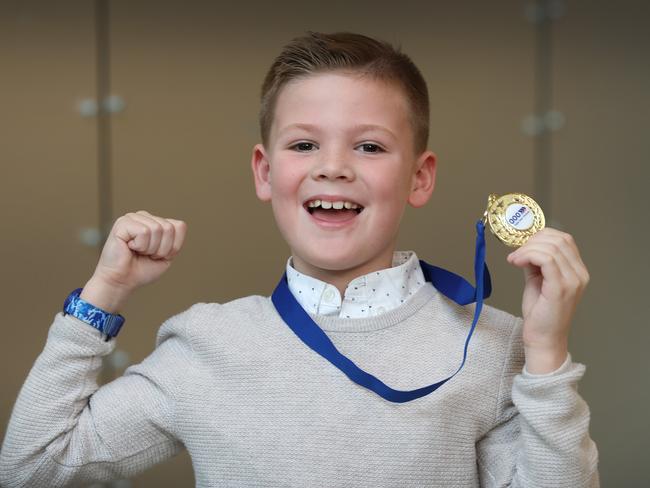 Junior Triple Zero Hero Miles Taylor, 7, with his medal. Picture: David Caird