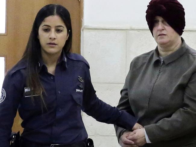 FILE - This Feb. 27, 2018 file photo, Australian Malka Leifer, right, is brought to a courtroom in Jerusalem. An Israeli court ruled Tuesday, May 26, 2020, that Leifer who is wanted on pedophilia charges in Australia, is fit to stand trial for extradition. The ruling capped a years-long legal battle in the case of Leifer, a former educator who is accused of sexually abusing former students. She has been fighting extradition from Israel for six years and the legal wrangle to bring her before an Australian court has caused a diplomatic strain between the two allies. (AP Photo/Mahmoud Illean, File)