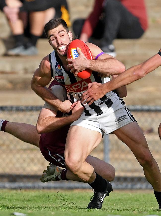 Payneham Norwood Union's Jonathan Giannini is tackled during last season’s Adelaide Footy League divisionone grand final against Prince Alfred Old Collegians. Picture: Tom Huntley