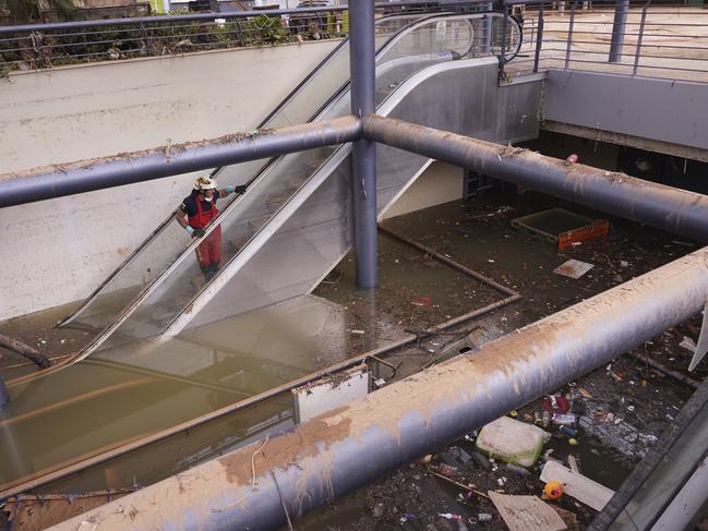 A firefighter looks at the flooded damage in a shopping centre after floods on the outskirts of Valencia, Spain. Picture: AP