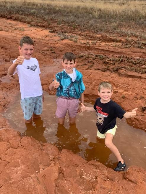 Samuel, Flynn and Patrick Fitzgerald playing in the floods. Picture: Leigh Fitzgerald