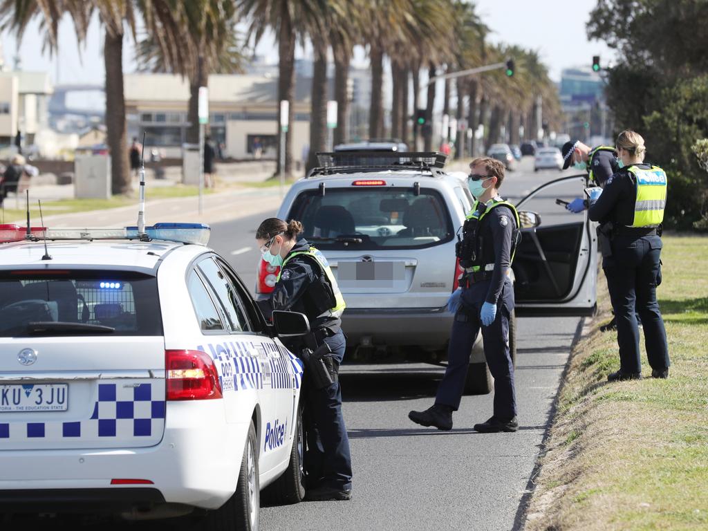 Police conduct roadside checks in Middle Park as people are seen exercising along the foreshore during a stage four COVID-19 lockdown. Picture: David Crosling