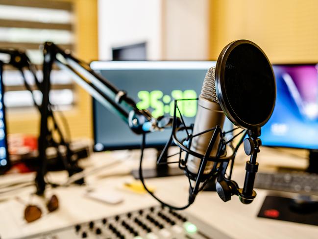 Microphone and mixer at the radio station studio broadcasting news. iStock