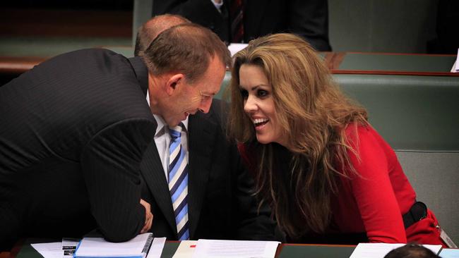 Then opposition leader Tony Abbott talks with Credlin during question time.