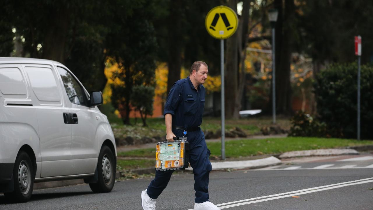 Police and Forensics are seen at the apartment complex on Thursday. Picture: NCA Newswire / Gaye Gerard