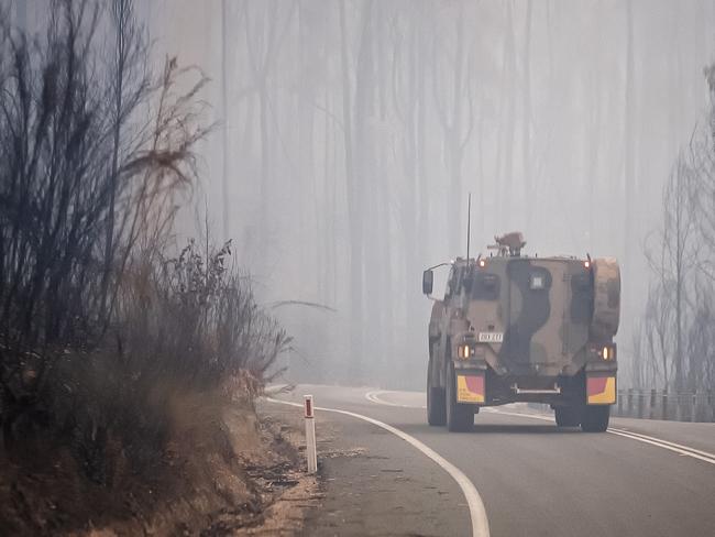 MALLACOOTA  AUSTRALIA - JANUARY 15:  Australian Defence Force  (ADF) Armoured vehicle personnel carrier is seen on the prince Highway near Mallacoota on January 15, 2020 , Australia. The Princes Highway between Mallacoota and Orbost remains closed to public due to the risk of falling trees following the devastating bushfires that have swept through East Gippsland in recent weeks. ADF armoured vehicles have been travelling the stretch of road to bring supplies in to Mallacoota, after the coastal town was cut off by fire on New Years Eve, forcing residents and holidaymakers to shelter on the beach. More than 1500 people were evacuated by Navy ships and helicopters to Melbourne in the following week.  Fires continue to burn across East Gippsland, with firefighters working to contain a number of blazes in the region. Four people have died and more than 1.3m hectares have been burned across the state following weeks of ongoing fires. (Photo by Luis Ascui/Getty Images)