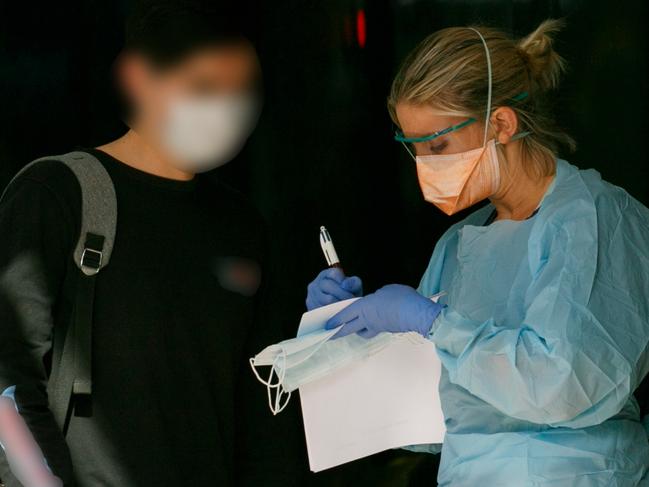 Patient in mask been seen by triage nurse at Northern Beaches Hospital's new COVID-19 clinic. Picture: Tim Pascoe