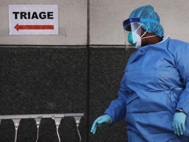 A medical worker walks outside of a special coronavirus intake area at Maimonides Medical Center in the Borough Park neighbourhood of the Brooklyn borough of New York City. Picture: Getty Images/AFP