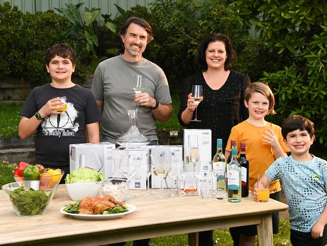 Darian Clark with wife Renee and their children Terran, Elliot and Raphael with the Coles glassware range. Picture: Nathan Hopkins