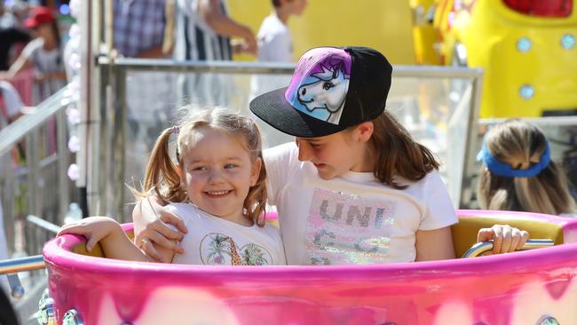 Mackenzie White, 9, and her sister Taitum, 2, at the Sydney Royal Easter Show. Picture: David Swift