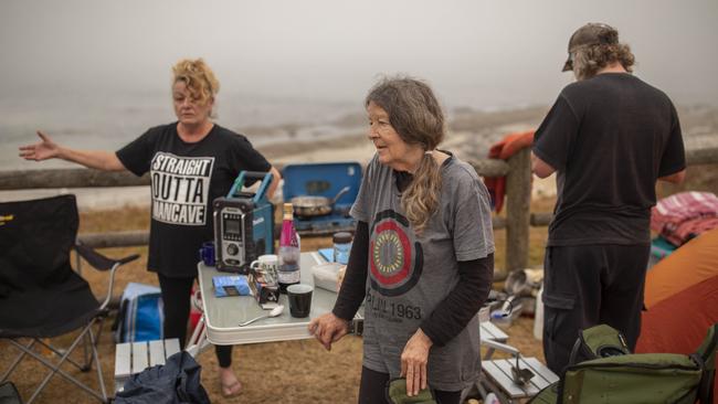 Bermagui resident Linda Livingston with friends Penny Shelling and Wade from Coolagolite spent last night on the beach at Bermagui. Picture: Sean Davey