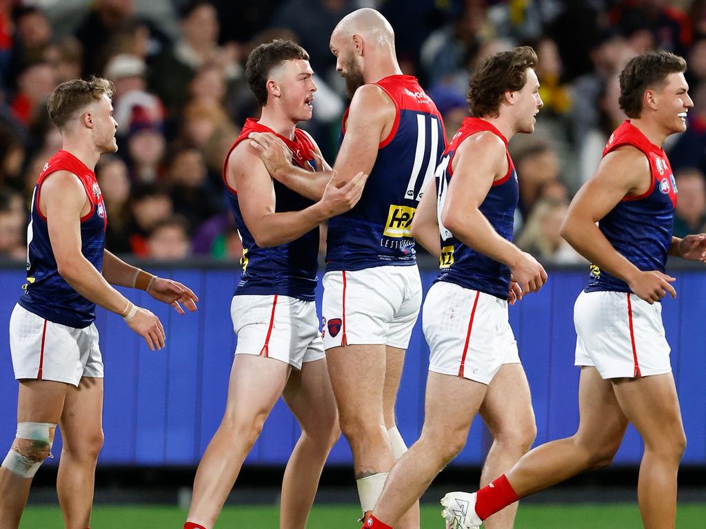 Daniel Turner is congratulated by skipper Max Gawn after one of his three goals on Wednesday night. Picture: Michael Willson/AFL Photos via Getty Images