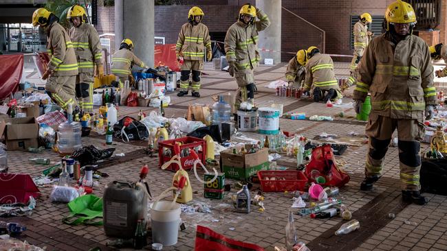 Firefighters search through an area used for making molotov cocktails inside the Hong Kong Polytechnic University. Picture: Getty