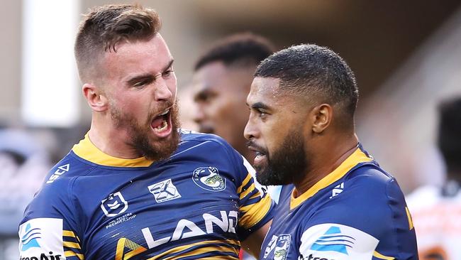 Clint Gutherson and Michael Jennings celebrate a try against the Tigers.