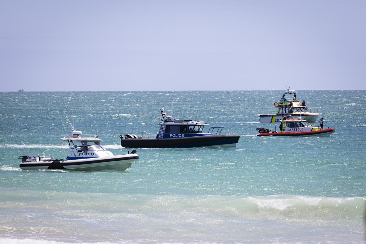 The search and rescue boats looking for the missing swimmer.