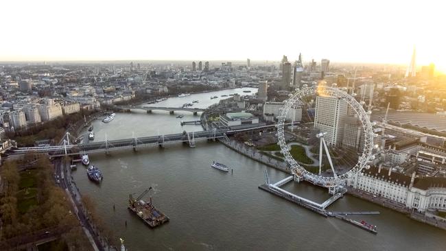 LONDON. UK City of London Skyline High Angle Aerial View of London Eye Wheel, Thames River, Hungerford Golden Jubilee Bridge, Whitehall Gardens along the Riverside at Sunset