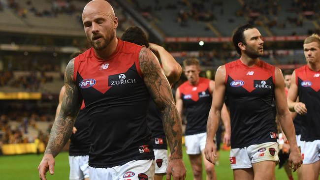 Nathan Jones leads the Demons off after his side was pummelled by the Hawks. Pic: AAP