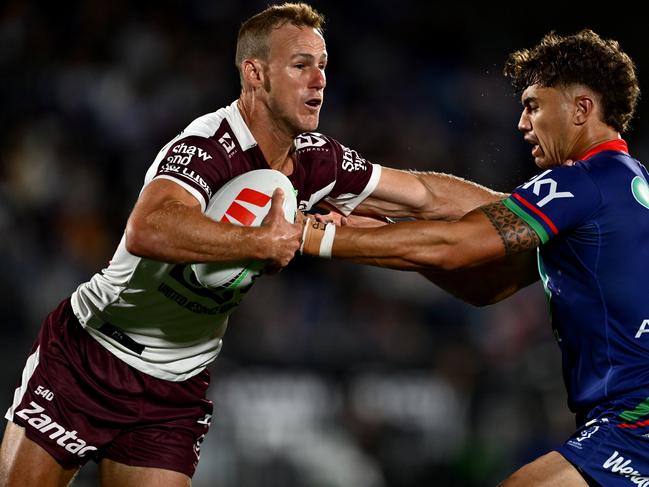 AUCKLAND, NEW ZEALAND - MARCH 14: DalyÃÂ Cherry-Evans of the Sea Eagles is tackled by Chanel Harris-Tavita of the Warriors during the round two NRL match between New Zealand Warriors and Manly Sea Eagles at Go Media Stadium, on March 14, 2025, in Auckland, New Zealand. (Photo by Hannah Peters/Getty Images)