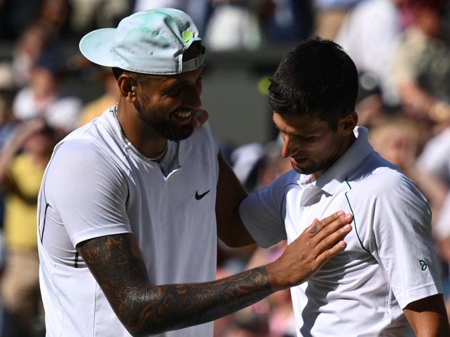 Australia's Nick Kyrgios (L) congratulates Serbia's Novak Djokovic for his victory during their men's singles final tennis match on the fourteenth day of the 2022 Wimbledon Championships at The All England Tennis Club in Wimbledon, southwest London, on July 10, 2022. (Photo by SEBASTIEN BOZON / AFP) / RESTRICTED TO EDITORIAL USE