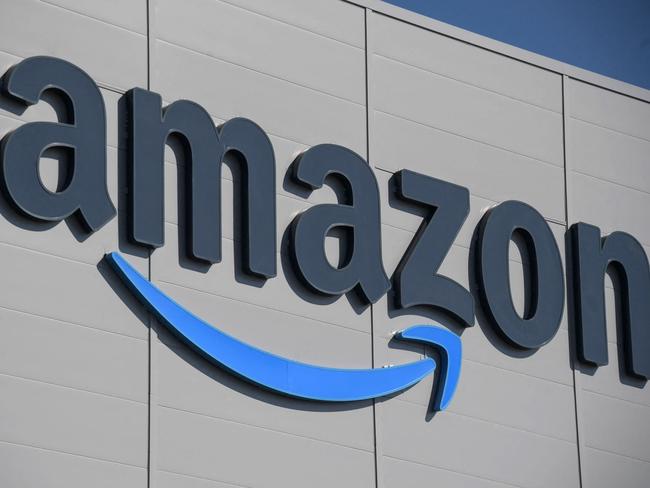 (FILES) In this file photo taken on September 23, 2021, the US giant Amazon logo is pictured on the opening day of a new distribution center in Augny, near Metz, eastern France. - Amazon announced on January 4, 2023 it will cut more than 18,000 jobs from its workforce, citing "the uncertain economy" and the fact that the online retail giant had "hired rapidly" during the pandemic. (Photo by SEBASTIEN BOZON / AFP)