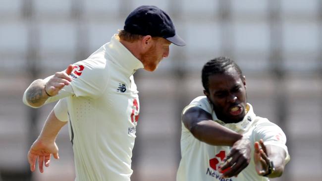 England's Jofra Archer (R) celebrates with England's Ben Stokes (L) after taking the wicket of West Indies' Roston Chase for 37 on the fifth day of the first Test cricket match between England and the West Indies at the Ageas Bowl in Southampton, southwest England on July 12, 2020. - West Indies were set a target of 200 to beat England in the first Test at Southampton on Sunday's fifth and final day. (Photo by Adrian DENNIS / POOL / AFP) / RESTRICTED TO EDITORIAL USE. NO ASSOCIATION WITH DIRECT COMPETITOR OF SPONSOR, PARTNER, OR SUPPLIER OF THE ECB