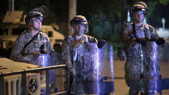 National Guard troops stand watch near a group of demonstrators at the Wauwatosa City Hall on October 09 in Wauwatosa, Wisconsin. Picture: Getty Images/AFP