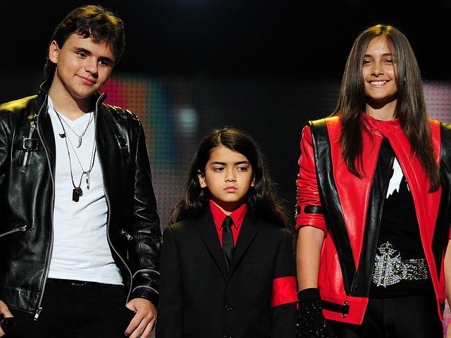 Michael Jackson's children, Prince Jackson (L), Blanket Jackson (C) and Paris Jackson (R) speak on stage during the 'Michael Forever' concert in memory of the late Michael Jackson at The Millenium Stadium in Cardiff, Wales on October 8, 2011. AFP PHOTO / LEON NEAL