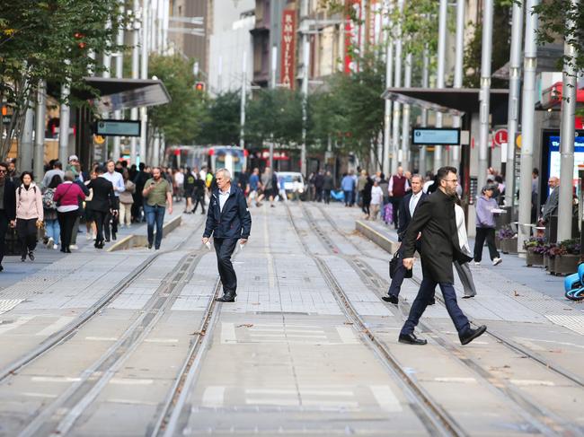 SYDNEY, AUSTRALIA - Newswire Photos - MAY 15: Members of the public are seen crossing George Street at midday in the Sydney CBD as the Federal Budget is handed down providing some relief for the public on cost of living. Picture: NCA Newswire / Gaye Gerard