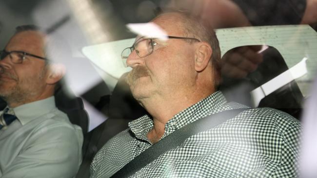 Greg Digance, husband of former Labor MP Annabel Digance, in the back seat of a car being driven into the Magistrates court after his arrest. Picture: Emma Brasier