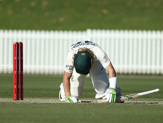 SYDNEY, AUSTRALIA - DECEMBER 08: Will Pucovski of Australia A lies injured after been struck in the helmet off the bowling of Kartik Tyagi of India A during day three of the International Tour match between Australia A and India A at Drummoyne Oval on December 08, 2020 in Sydney, Australia. (Photo by Jason McCawley/Getty Images)