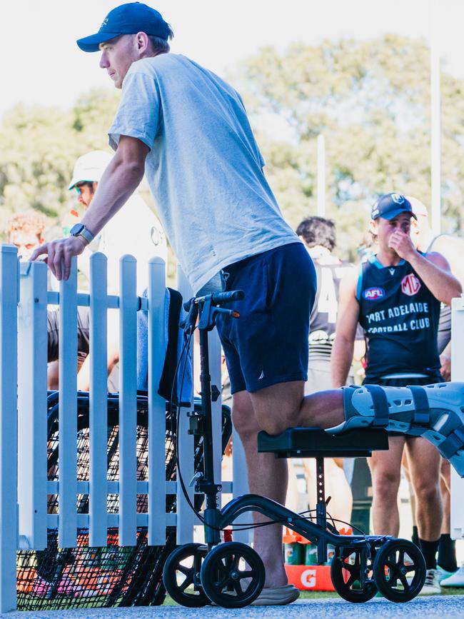 Todd Marshall watching Port Adelaide training after having surgery to repair his ruptured Achilles. Credit: PAFC