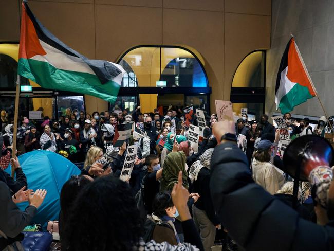 Pro-Palestinian students hold a sit-in in Melbourne on May 15, 2024 at Melbourne University's Arts West building, which the students have temporarily renamed as "Mahmoud's Hall" after Mahmoud Al Haq, a prospective University of Melbourne student, who died in Gaza. (Photo by Martin KEEP / AFP)