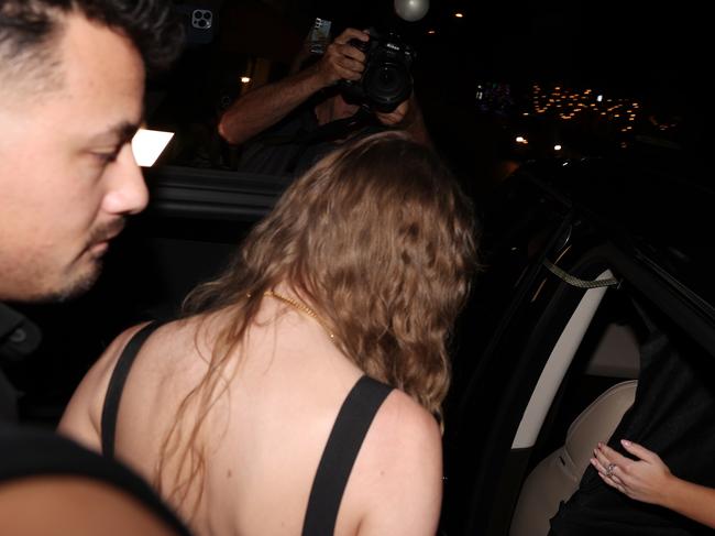 In her getaway car- Taylor Swift hops into a black Range Rover outside Pellegrino 2000.