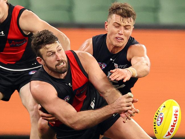 AFL Round 4.  Essendon v Carlton at the MCG. 27/06/2020.  Cale Hooker of the Bombers clears infant of Patrick Cripps of the Blues    . Pic: Michael Klein