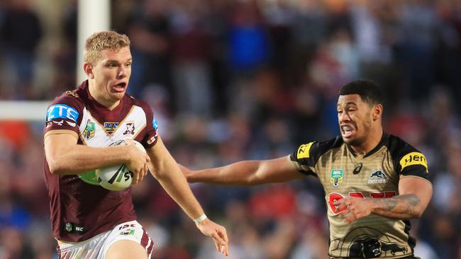 Tom Trbojevic of Manly evades the grasp of Peter Wallace of the Panthers during the Manly Sea Eagles v Penrith Panthers NRL round 14 game at Brookvale Oval. pic Mark Evans