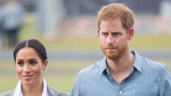 DUBBO, AUSTRALIA - OCTOBER 17:  Meghan, Duchess of Sussex and Prince Harry, Duke of Sussex attend a naming and unveiling ceremony for the new Royal Flying Doctor Service aircraft at Dubbo Airport on October 17, 2018 in Dubbo, Australia. The Duke and Duchess of Sussex are on their official 16-day Autumn tour visiting cities in Australia, Fiji, Tonga and New Zealand.  (Photo by Dominic Lipinski - Pool/Getty Images)