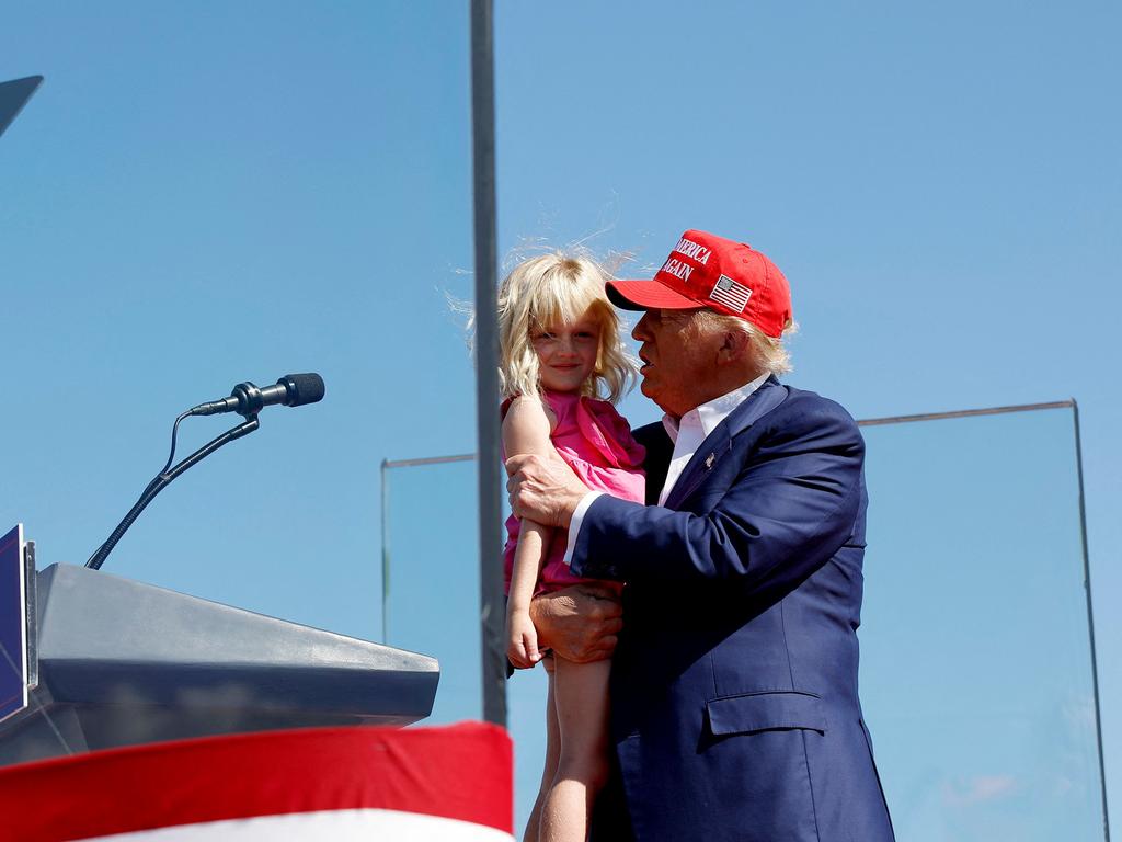 Donald Trump holds his granddaughter Carolina on stage at a campaign rally at the Aero Center Wilmington in Wilmington, North Carolina on the weekend. Picture: Getty Images via AFP