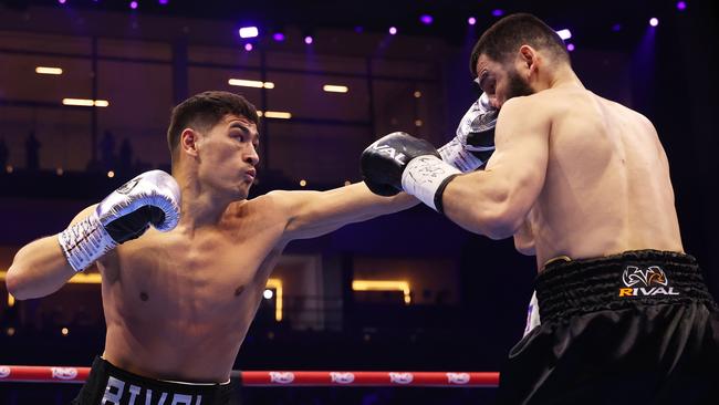 Dmitrii Bivol punches Artur Beterbiev. Photo by Richard Pelham/Getty Images.