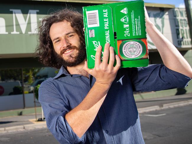 Harry Vincent and his case of beer after Dan Murphy’s announces it will be further restricting customers to counteract stockpiling among customers. Picture: Mark Stewart