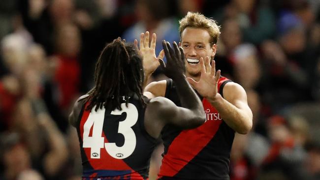 Anthony McDonald-Tipungwuti (left) and Darcy Parish celebrate a goal late against the Dockers. Picture: AFL Photos via Getty Images