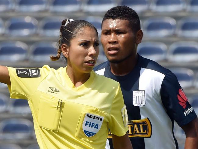 Peruvian FIFA female referee Melany Bermejo (L) arbitrates footballers a football match at a stadium in Lima, Peru, on April 24, 2016. From the 65 Peruvian acting referees, 22 are subscribed to FIFA and eight of them are women, none of them with activities in the first division football due to the FIFA physical requirements. / AFP PHOTO / CRIS BOURONCLE