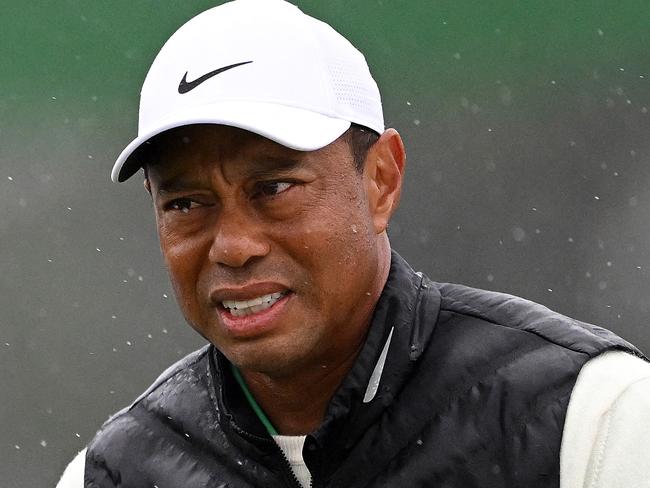 (FILES) In this file photograph taken on April 8, 2023, Tiger Woods of the US reacts on the 18th green during the continuation of the weather delayed second round of the 2023 Masters Tournament at Augusta National Golf Club in Augusta, Georgia. - Five-time winner Tiger Woods, who limped through an awful, bogey-strewn start to his rain-halted third round of the Masters, pulled out of the tournament with a foot injury organizers said on aPRIL 9, 2023. (Photo by ROSS KINNAIRD / GETTY IMAGES NORTH AMERICA / AFP)