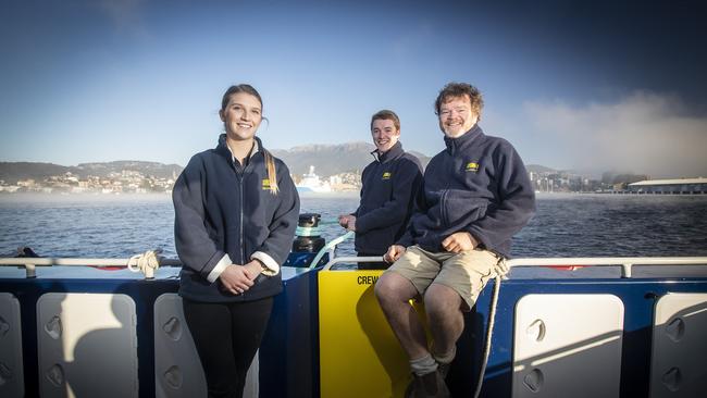 Staff Hannah Cox and Ben McKean with owner Rob Pennicott (right) on the River Derwent. Picture: LUKE BOWDEN