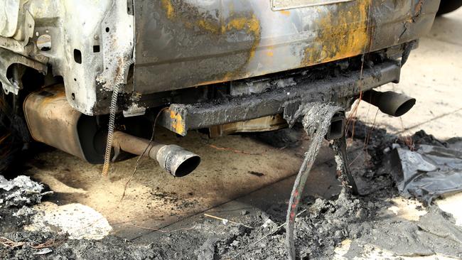 The remains of two burnt cars in the driveway of a Reigate Rd Highton property. Picture: Alison Wynd