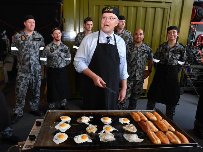 Prime Minister Scott Morrison cooks breakfast on the Canberra class HMAS Adelaide helicopter landing dock ship after the 2018 Asia-Pacific Economic Cooperation (APEC) forum in Port Moresby, Papua New Guinea, Sunday, November 18, 2018. (AAP Image/Mick Tsikas) NO ARCHIVING