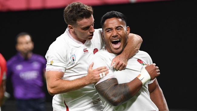 England's centre Manu Tuilagi (R) celebrates with England's fly-half George Ford after scoring a try during the Japan 2019 Rugby World Cup Pool C match between England and Tonga at the Sapporo Dome in Sapporo on September 22, 2019. (Photo by WILLIAM WEST / AFP)