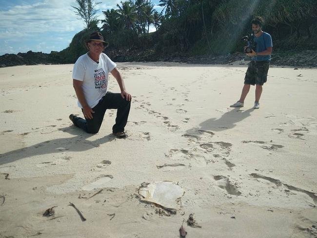 Blaine Alan Gibson with the latest piece of possible MH370 debris found on Riake Beach, Madagascar. Picture: Facebook