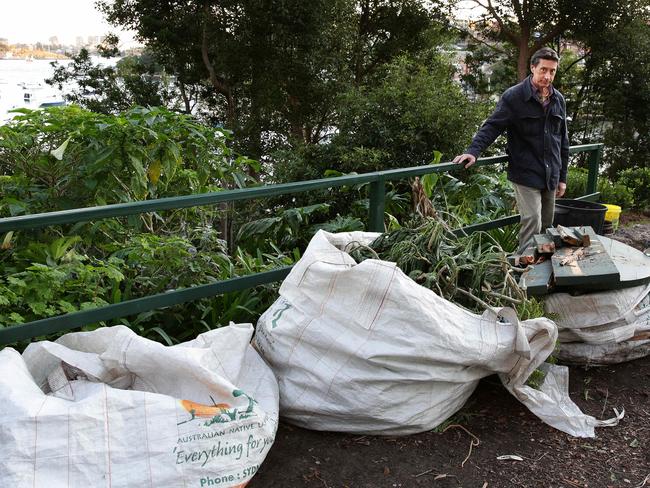 Ian Curdie with some of the many bags of dead plants and rubbish.