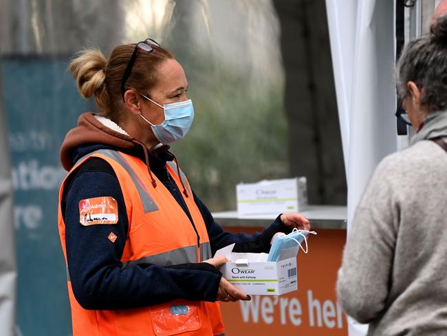 NSW Heath workers hand out face masks to people in Sydney. Picture: NCA NewsWire/Bianca De Marchi