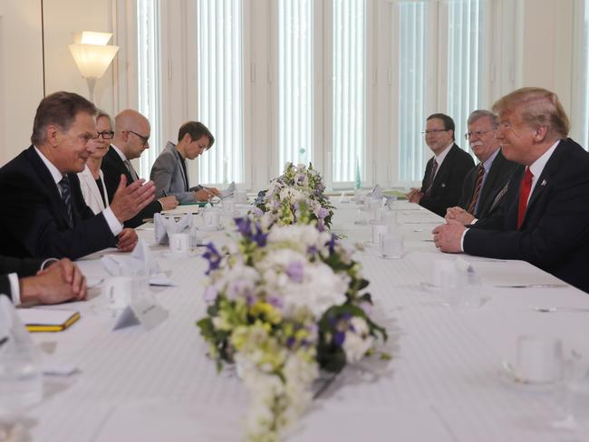 Finnish President Sauli Niinisto, left, and Mr Trump, right, sit down for a working breakfast. Picture: Pablo Martinez Monsivais/AP Photo